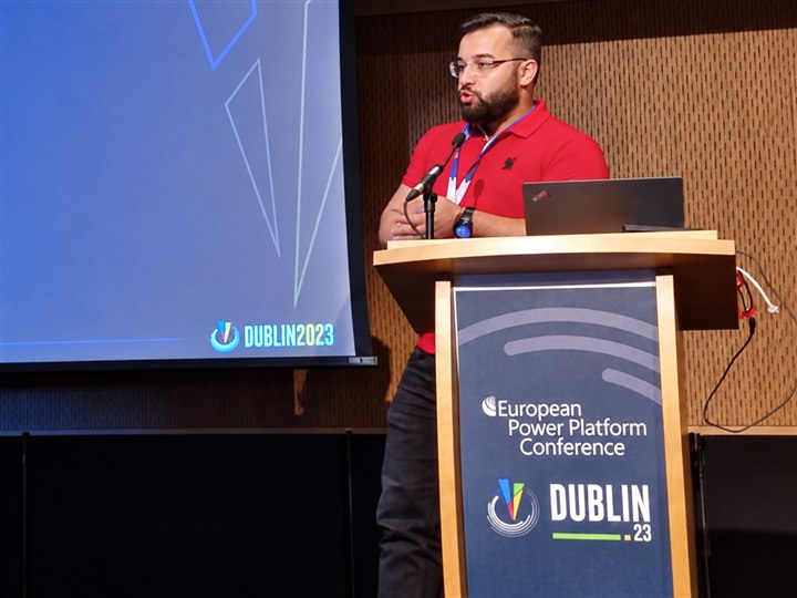Abdellah speaking at a podium with European Power Platform Conference and Dublin 2023 signage
